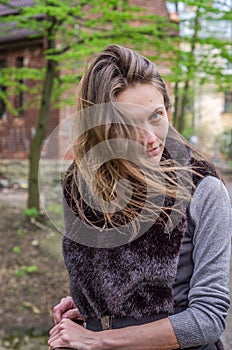 A young beautiful girl with long hair walks through the spring Stryjsky park in Lviv