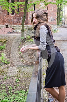 A young beautiful girl with long hair walks through the spring Stryjsky park in Lviv