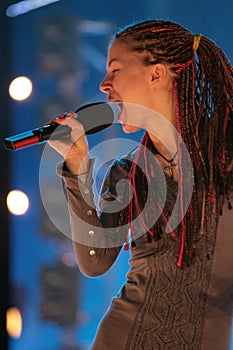Young beautiful girl with a microphone in hand