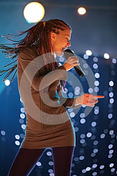 Young beautiful girl with a microphone in hand