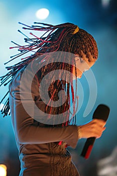 Young beautiful girl with a microphone in hand