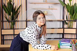 Young beautiful girl in office style looks at the camera.