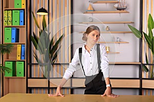 Young beautiful girl in office style looks at the camera.