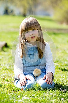 Young beautiful girl, playing with little newborn chick in the p