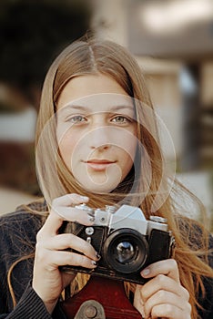 Young beautiful girl portrait with phot-film camera