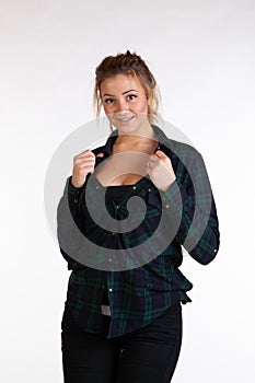 Young beautiful girl posing in the studio, standing in shirt