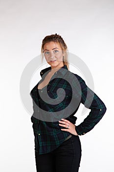 Young beautiful girl posing in the studio, standing in shirt