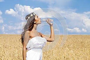 Young beautiful girl quenches thirst