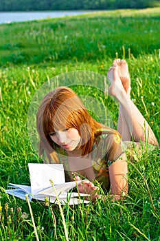 Young beautiful girl reading a book