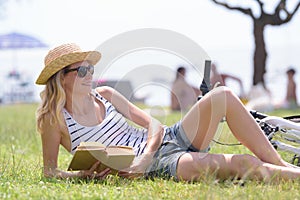 Young beautiful girl reading book outdoor