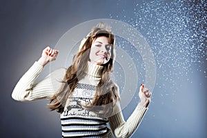 Young beautiful girl rejoices to snow