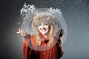 Young beautiful girl rejoices to snow