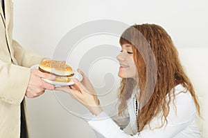 Young beautiful girl rejoices to tasty meal