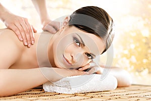 Young and beautiful girl relaxing in a spa salon