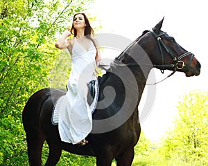 Young beautiful girl riding on horse