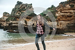 A young beautiful girl runs around the Atlantic coast in Portugal and enjoys life.