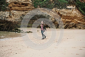 A young beautiful girl runs around the Atlantic coast in Portugal and enjoys life.