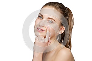 Young beautiful girl smears the face cream photo