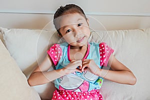 Young beautiful girl smiling in love showing heart symbol and shape with hands in my house.