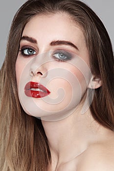 Young beautiful girl with smoky eye makeup and red l