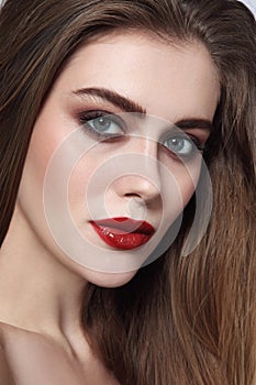 Young beautiful girl with smoky eye makeup and red l