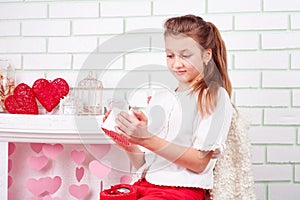 Young beautiful girl surprised looking in present box