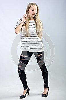 Young beautiful girl in sweater and jeans