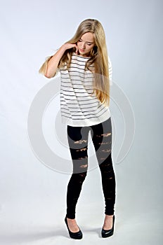 Young beautiful girl in sweater and jeans