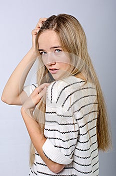 Young beautiful girl in sweater and jeans