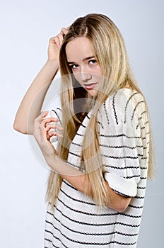 Young beautiful girl in sweater and jeans