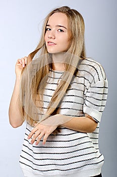 Young beautiful girl in sweater and jeans