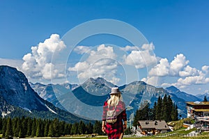 Young beautiful girl traveler , mountains Alps background,