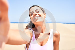Young beautiful girl on vacation wearing swimsuit smiling happy and confident