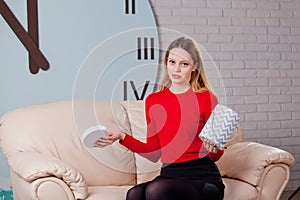 Young beautiful girl with Valentines day gift box, disappointed