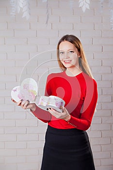 Young beautiful girl with Valentines day gift in heart shaped bo