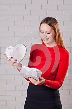 Young beautiful girl with Valentines day gift in heart shaped bo