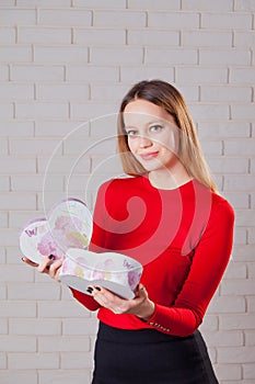 Young beautiful girl with Valentines day gift in heart shaped bo