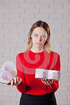 Young beautiful girl with Valentines day gift in heart shaped bo