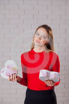 Young beautiful girl with Valentines day gift in heart shaped bo