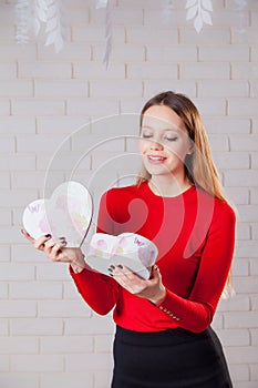 Young beautiful girl with Valentines day gift in heart shaped bo