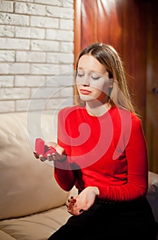 Young beautiful girl with Valentines day ring gift in heart shaped box, disappointed