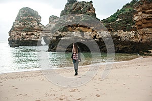 Young beautiful girl is walking along the Atlantic coast.