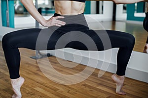 Young beautiful girl wearing fashion sports wear doing exercise on mat at loft gym, top view