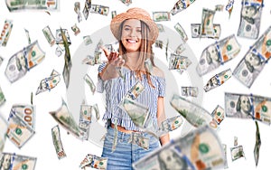 Young beautiful girl wearing hat and t shirt smiling friendly offering handshake as greeting and welcoming