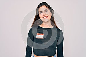 Young beautiful girl wearing Hello my name is sticker over isolated background with a happy face standing and smiling with a