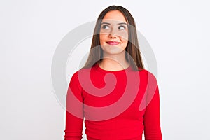 Young beautiful girl wearing red casual t-shirt standing over isolated white background smiling looking to the side and staring