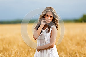 Young beautiful girl in a wheat field