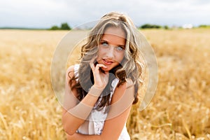 Young beautiful girl in a wheat field