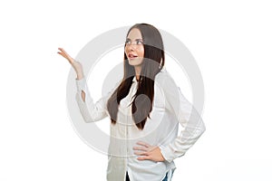 Young, beautiful girl on a white background points his hands at the place for promo, offers or advertising