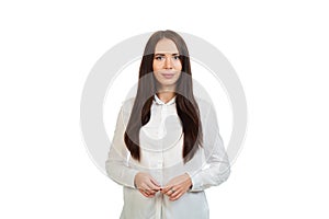 Young, beautiful girl in a white shirt on a white background